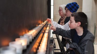 Children lighting remembrance candles