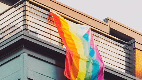 Pride flag hanging from a balcony Pride flag hanging from a balcony