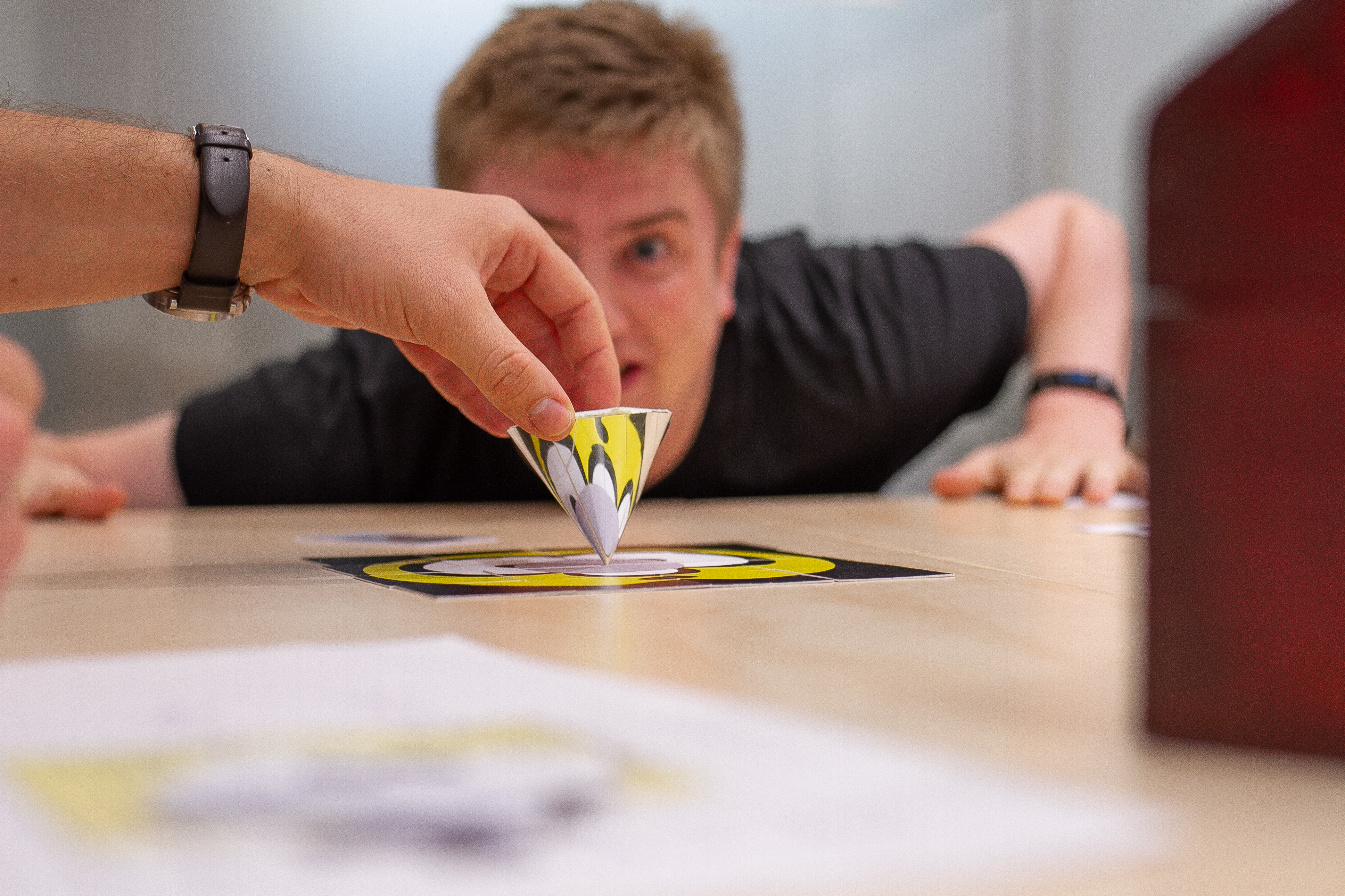 Man looks at upside down mirror cone