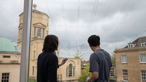 two males in the Common room with Observatory in background