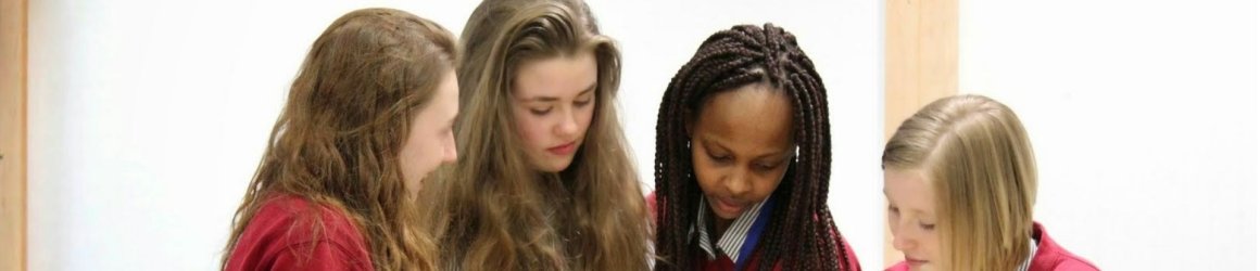 Four participants at It All Adds Up working on maths problems