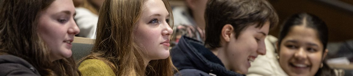 Four attendees watching a lecture