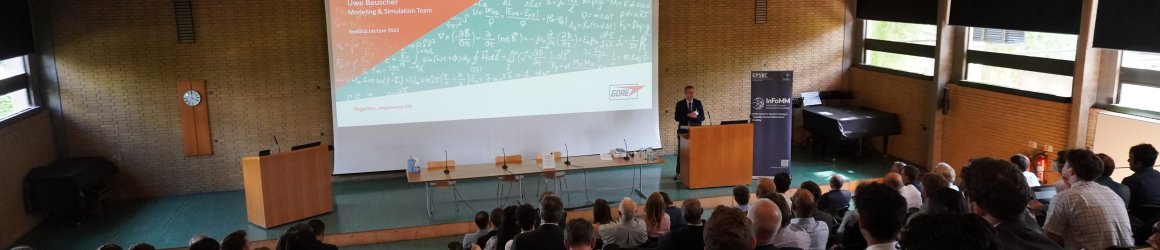 Reddick lecture 2022. Speaker at the front of a large lecture theatre