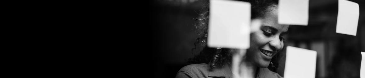 A mathematician writing on glass