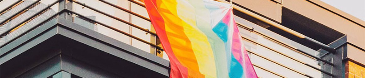 Pride flag hanging from a balcony Pride flag hanging from a balcony