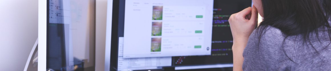 person looking at a computer screen and editing a web page