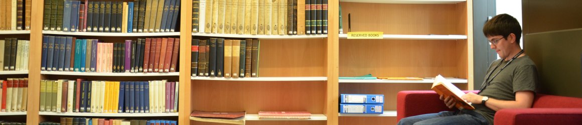 A student reading in the Whitehead Library at the Mathematical Institute.
