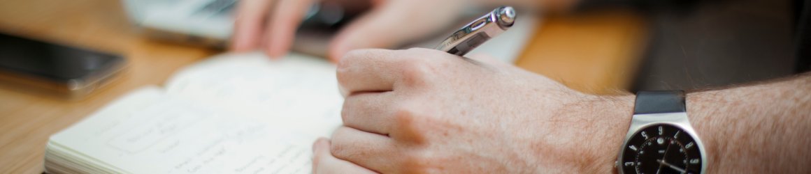 close up of a table top with notebook and laptop