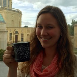 Mathematical Institute coffee cup held by Bernadette