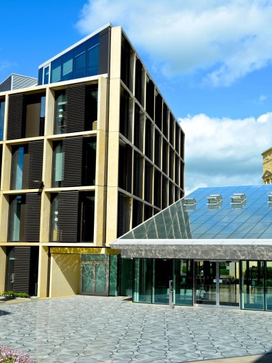 Photo of the Andrew Wiles Building front entrance on a sunny day