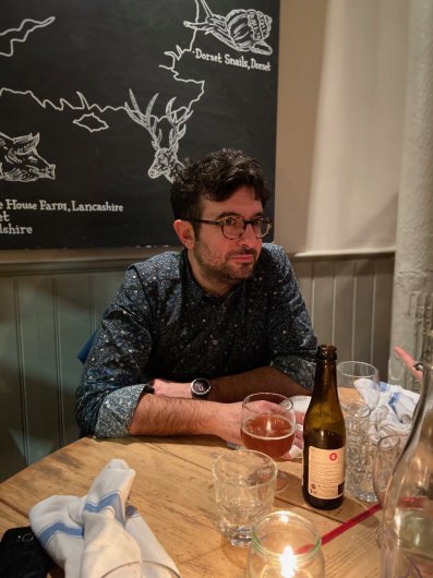 George Deligiannidis, sitting in the pub with a drink