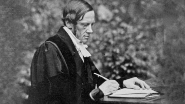 Photograph of Bartholomew Price writing at a desk Photograph of Bartholomew Price writing at a desk