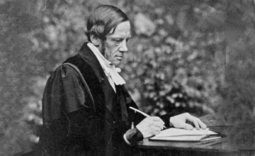 Photograph of Bartholomew Price writing at a desk