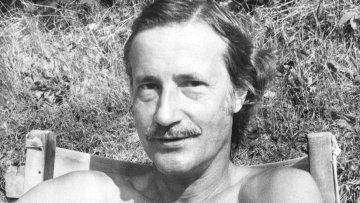 Image of Christopher Strachey sitting on a chair