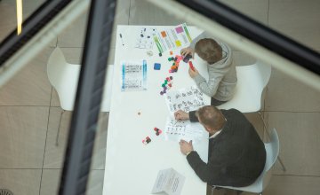 Image from last year's festival of children doing puzzles
