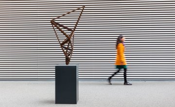 Photo of exhibit with someone walking past