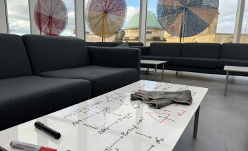 Photo of Common Room white tables with maths on them