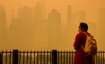 A woman wears an N95 face mask to protect against lung damage from wildfire smoke