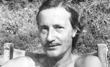 Image of Christopher Strachey sitting on a chair