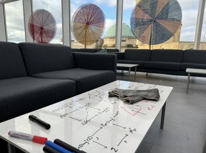 Photo of Common Room white tables with maths on them