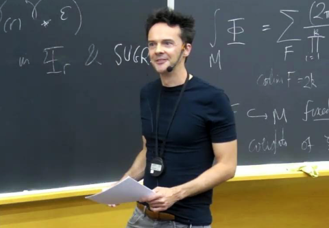 James Sparks lecturing in front of black board