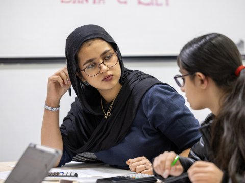 Two girls discussing mathematics
