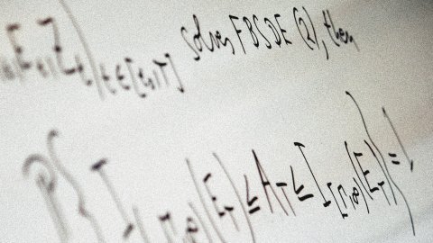 Mathematical equations written on a whiteboard