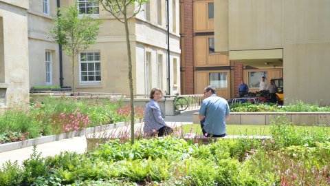 2 people sat on the benches in the pocket courtyard