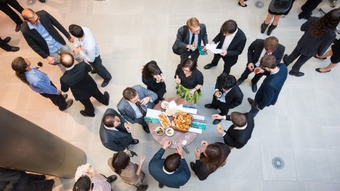 View down through a crystal to people at a function in the mezzanine