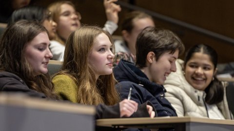 Four attendees watching a lecture