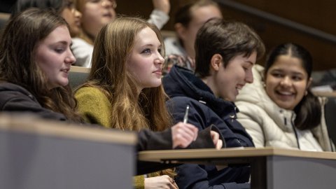 Four attendees watching a lecture