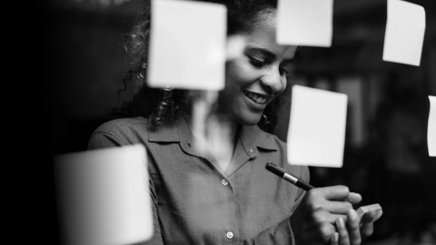 A mathematician writing on glass