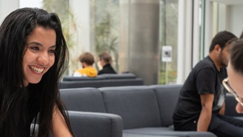 Students in the Common Room at the Mathematics Institute with two women in the foreground