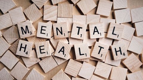 An image of the words "mental health" spelled out using scrabble tiles.