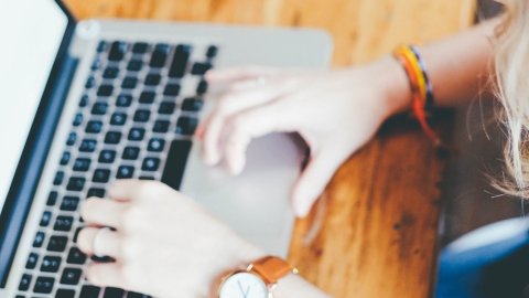 a person typing on a laptop